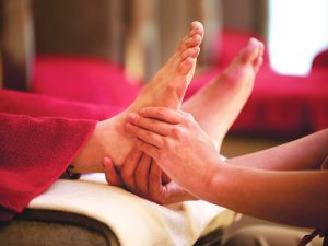 Woman receiving foot massage at Kenko Wellness