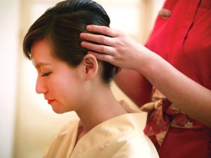 Woman receiving head massage at Kenko Wellness